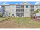 Back exterior of building shows screened porches at 133 Puffin Dr. # 3-E, Pawleys Island, SC 29585