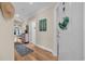 Hallway that features hardwood floors, a decorative mirror, and a view of the living room at 133 Puffin Dr. # 3-E, Pawleys Island, SC 29585