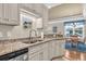 Granite counters and stainless appliances highlight the cozy kitchen space at 133 Puffin Dr. # 3-E, Pawleys Island, SC 29585