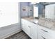 Bathroom featuring white cabinets, granite countertops, and a mirror with bright lighting at 1411-A N Ocean Blvd., Surfside Beach, SC 29575