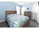 Cozy bedroom with blue walls, light-colored furnishings, and neutral patterned bedding at 1411-A N Ocean Blvd., Surfside Beach, SC 29575