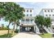 Beautiful raised beach house with blue siding, white trim, and a covered porch near green foliage at 1411-A N Ocean Blvd., Surfside Beach, SC 29575