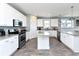 Well-lit kitchen with white cabinetry, stainless steel appliances, and granite countertops at 1411-A N Ocean Blvd., Surfside Beach, SC 29575