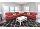 Bright living room with beach views, red sofas, decorative pillows, and a black and white rug at 1411-A N Ocean Blvd., Surfside Beach, SC 29575