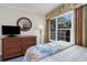 Relaxing bedroom featuring a dresser, TV, and tropical-themed decor at 14290 Ocean Hwy. # 101, Pawleys Island, SC 29585