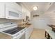 Cozy kitchen features white cabinets, modern appliances, and stylish tile flooring at 14290 Ocean Hwy. # 101, Pawleys Island, SC 29585