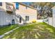 View of a spacious backyard with a walkway, complemented by lush green grass and partial fencing at 15 Flaggpoint Ln., Murrells Inlet, SC 29576