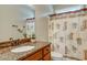 Cozy bathroom featuring granite countertop vanity, palm tree-themed shower curtain, and decorative accents at 15 Flaggpoint Ln., Murrells Inlet, SC 29576