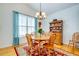 Bright dining room features a round wood table, china cabinet, and ample natural light from large window at 15 Flaggpoint Ln., Murrells Inlet, SC 29576