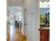 Hallway leading to kitchen and bathroom with hardwood floors and neutral paint, showing continuity of design at 15 Flaggpoint Ln., Murrells Inlet, SC 29576