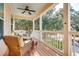 Comfortable porch with wicker furniture, ceiling fan, and view of the landscaped yard at 15 Flaggpoint Ln., Murrells Inlet, SC 29576