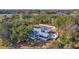 Aerial view of a home with large trees, a screened porch, and an outdoor seating area at 161 Twelve Oaks Dr., Pawleys Island, SC 29585