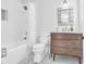 Bright bathroom features a shower-tub combo, marble floors, and a wood vanity with modern finishes at 161 Twelve Oaks Dr., Pawleys Island, SC 29585