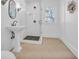 Modern bathroom features a pedestal sink, glass shower, and window with a view at 161 Twelve Oaks Dr., Pawleys Island, SC 29585