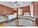 Cozy bedroom with two beds, wood paneled walls, and a window with sheer curtains at 161 Twelve Oaks Dr., Pawleys Island, SC 29585