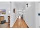 Hallway with beautiful hardwood flooring, built-in shelves, and modern light fixtures at 161 Twelve Oaks Dr., Pawleys Island, SC 29585