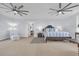 Bright bedroom features two ceiling fans, light blue walls, and an ensuite seating area at 161 Twelve Oaks Dr., Pawleys Island, SC 29585