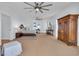 Spacious primary bedroom with light blue walls, a ceiling fan, and large windows for ample natural light at 161 Twelve Oaks Dr., Pawleys Island, SC 29585