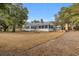 Charming back view of the home featuring a screened-in porch and outdoor fireplace at 161 Twelve Oaks Dr., Pawleys Island, SC 29585