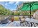 Relaxing balcony with an outdoor dining area offers lush green views and a shady umbrella at 163 Heron Marsh Dr. # 61, Pawleys Island, SC 29585