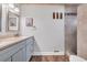 Bathroom featuring a stylish vanity, modern fixtures, and a walk-in shower with tiled surround at 163 Heron Marsh Dr. # 61, Pawleys Island, SC 29585