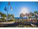 Elegant clubhouse entrance framed by palm trees and manicured landscaping, offering a warm welcome at 163 Heron Marsh Dr. # 61, Pawleys Island, SC 29585