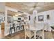 Open-concept dining area showcasing a modern chandelier, wood ceiling, and breakfast bar with stainless steel appliances at 163 Heron Marsh Dr. # 61, Pawleys Island, SC 29585