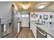 Modern kitchen featuring stainless steel appliances, white cabinets, granite countertops, and unique wood ceiling at 163 Heron Marsh Dr. # 61, Pawleys Island, SC 29585