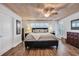 Serene main bedroom featuring a ceiling fan, shuttered windows, wood plank ceiling, and neutral decor at 163 Heron Marsh Dr. # 61, Pawleys Island, SC 29585