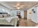 Comfortable main bedroom with a ceiling fan, wood plank ceiling, and barn door to the bathroom at 163 Heron Marsh Dr. # 61, Pawleys Island, SC 29585