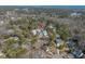 Expansive aerial view showcasing a tranquil neighborhood surrounded by green trees and distant ocean views at 170 Minnow Dr., Pawleys Island, SC 29585