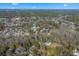 The aerial view shows the home nestled among trees in a quiet neighborhood with the blue sky overhead at 170 Minnow Dr., Pawleys Island, SC 29585