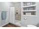 Modern bathroom featuring a spacious walk-in shower with tiled walls, a white shower curtain and built-in shelving at 170 Minnow Dr., Pawleys Island, SC 29585