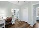 Bright bedroom features a work desk, wood floors, and a bathroom with built-in shelving and a walk-in shower at 170 Minnow Dr., Pawleys Island, SC 29585