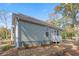 Charming exterior view of the home showing the siding, roof, and entry door from the side of the house at 170 Minnow Dr., Pawleys Island, SC 29585