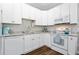 Well-lit kitchen features white cabinets and hardwood floors at 170 Minnow Dr., Pawleys Island, SC 29585