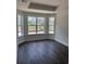 Bedroom with wood-look floors and large windows offering ample natural light at 171 Glengrove Lane, Murrells Inlet, SC 29576