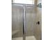 Tiled shower with clear glass door and black hardware at 171 Glengrove Lane, Murrells Inlet, SC 29576