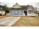 Charming blue home with a covered front porch, complemented by a spacious driveway at 1741 Rice St., Georgetown, SC 29440