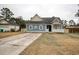 Lovely blue home showcasing a delightful porch and driveway at 1741 Rice St., Georgetown, SC 29440