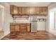 Small kitchenette featuring wood cabinets, counters, shelving, and stainless steel refrigerator at 1741 Rice St., Georgetown, SC 29440