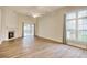 Bright living room features wood floors, a cozy fireplace, and natural light from large windows and sliding glass doors at 1741 Rice St., Georgetown, SC 29440