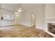 Bright living room features wood floors, a cozy fireplace, and a partial view to kitchen at 1741 Rice St., Georgetown, SC 29440