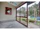 Relaxing screened porch overlooking the backyard with a vintage barbeque sign at 1741 Rice St., Georgetown, SC 29440