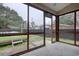 Enclosed porch view showcasing the backyard, including a partially covered above ground pool at 1741 Rice St., Georgetown, SC 29440