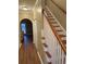 Inviting hallway features wood floors, staircase and open doorway to the living room at 1742 Low Country Pl. # A, Myrtle Beach, SC 29577