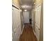 Hallway featuring wood floors, neutral walls, and multiple storage closets at 1742 Low Country Pl. # A, Myrtle Beach, SC 29577