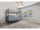 Bedroom features a black bunk bed with a futon, carpet flooring, and a bright window at 1801 Heirloom Dr., Conway, SC 29527