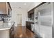 Modern kitchen featuring stainless steel appliances, granite countertops, and dark wood cabinets at 1801 Heirloom Dr., Conway, SC 29527