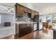 Stylish kitchen with stainless steel appliances, dark wood cabinets, and a view into the adjacent living room at 1801 Heirloom Dr., Conway, SC 29527